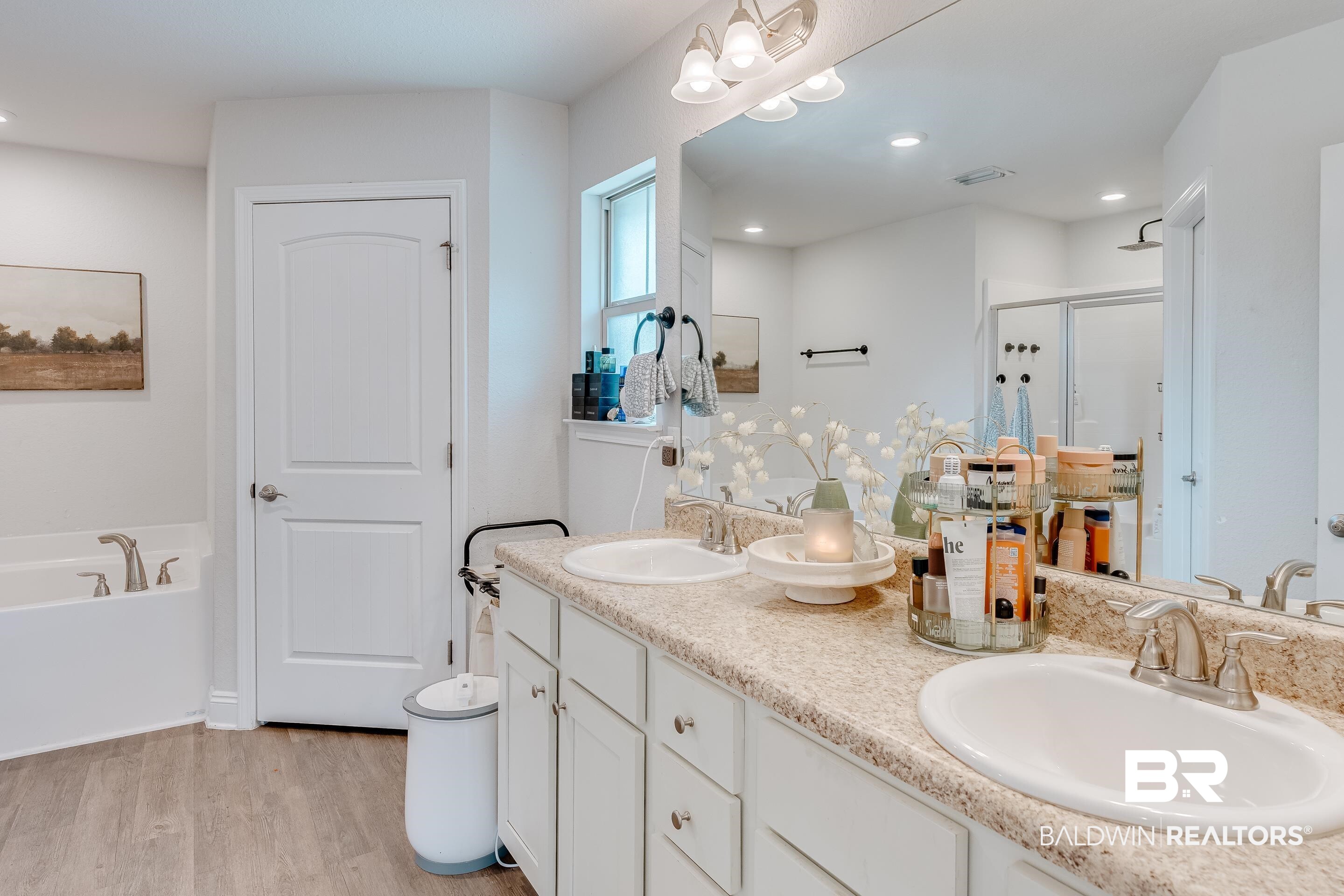 2215 Fernwood Loop West Semmes, AL 36575 - Photo 15 of 40 Double vanity with undermount sinks, wood-finish flooring, built-in bathtub, glass-enclosed shower, and recessed lighting
