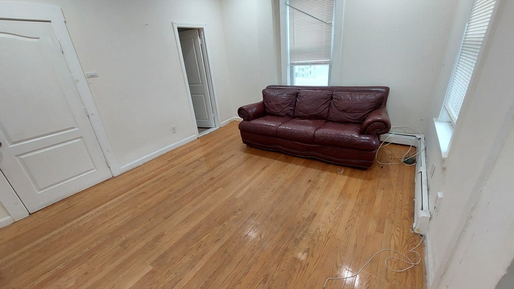 124 Marcella Street, Unit 1 Boston, MA 02119 - Photo 3 of 13 a view of a livingroom with furniture and wooden floor