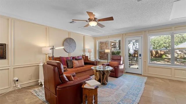 a living room with furniture a window and a chandelier