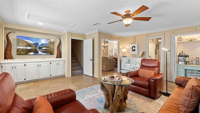 a living room with furniture and view of kitchen