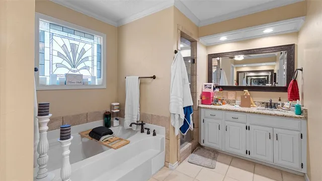 a bathroom with a sink mirror and tub