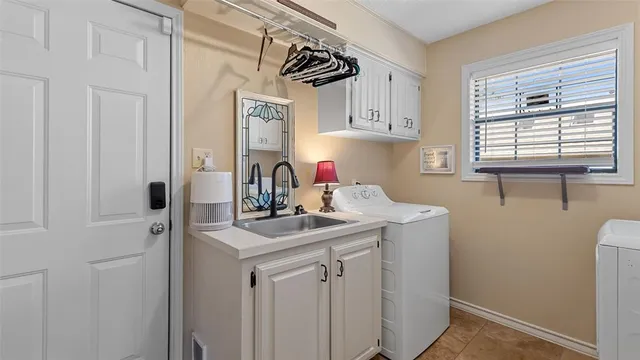 a kitchen with a sink cabinets and a window