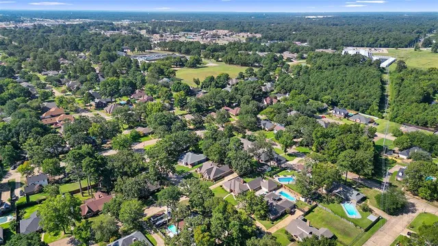 an aerial view of street and residential houses with outdoor space