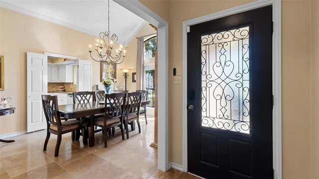 a view of a dining room with furniture and chandelier