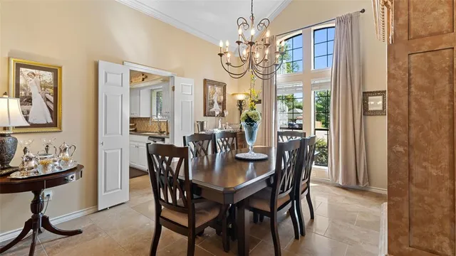 a view of a dining room with furniture a chandelier and wooden floor