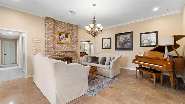 a living room with furniture a piano and a chandelier