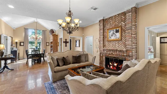 a living room with furniture fireplace and chandelier