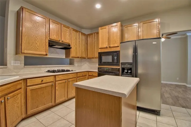 a kitchen with stainless steel appliances a refrigerator sink and cabinets