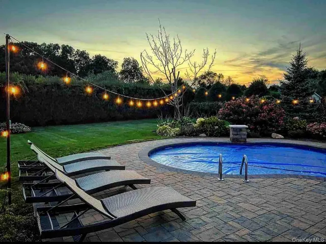 a view of a backyard with sitting area