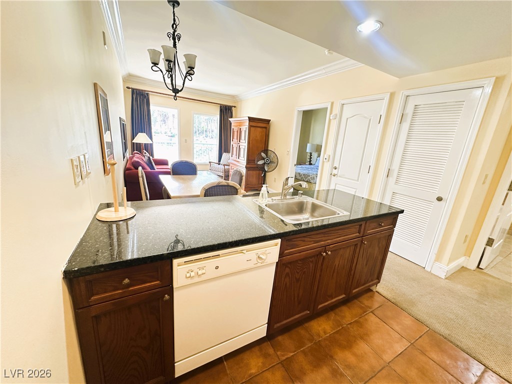 30 Strada Di Villaggio, Unit 531 Henderson, NV 89011 - Photo 41 of 42 Kitchen with white dishwasher, open floor plan, ornamental molding, dark tile patterned flooring, and dark carpet