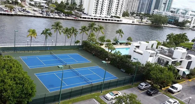 an aerial view of a balcony with chairs and a table