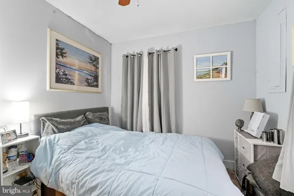 a bedroom with a bed and a painting on the wall