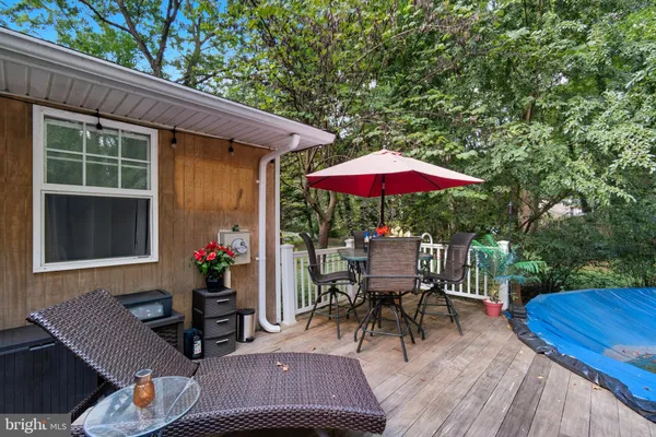 a view of a patio with a table and chairs under an umbrella