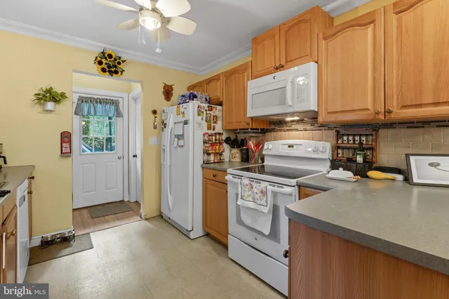 a kitchen with a refrigerator and a stove top oven