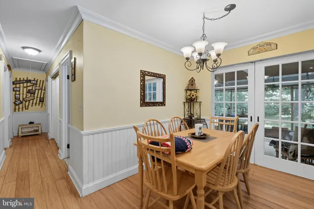 a view of a dining room with furniture wooden floor and chandelier
