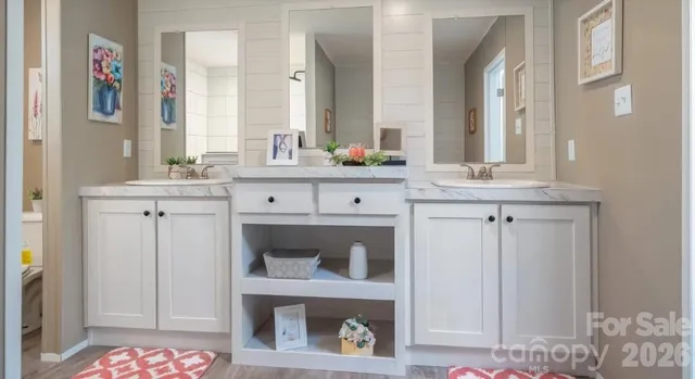 a spacious bathroom with a granite countertop double vanity sink and a mirror