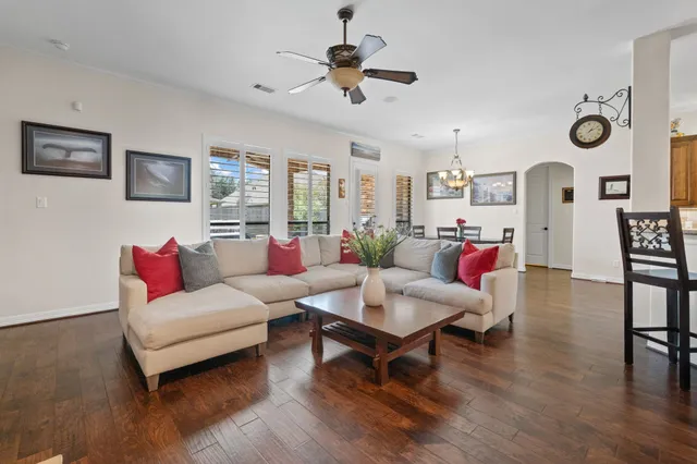 a living room with furniture and wooden floor