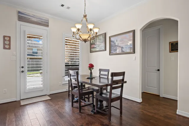 a view of a dining room with furniture wooden floor and chandelier