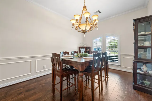 a view of a dining room with furniture wooden floor and chandelier