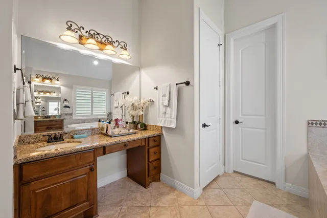 a spacious bathroom with a tub sink and shower