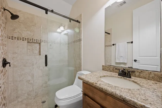 an empty room with wooden floor closet and windows