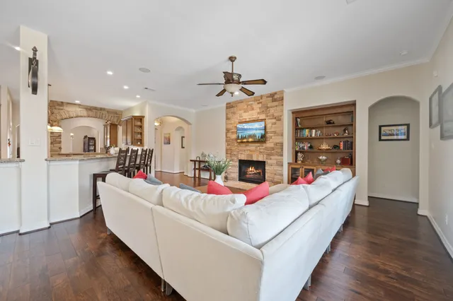 a living room with furniture fireplace and flat screen tv