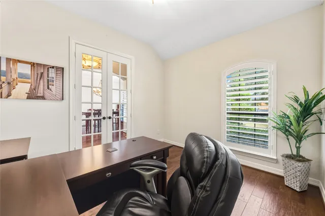 a view of a dining room with furniture wooden floor and chandelier