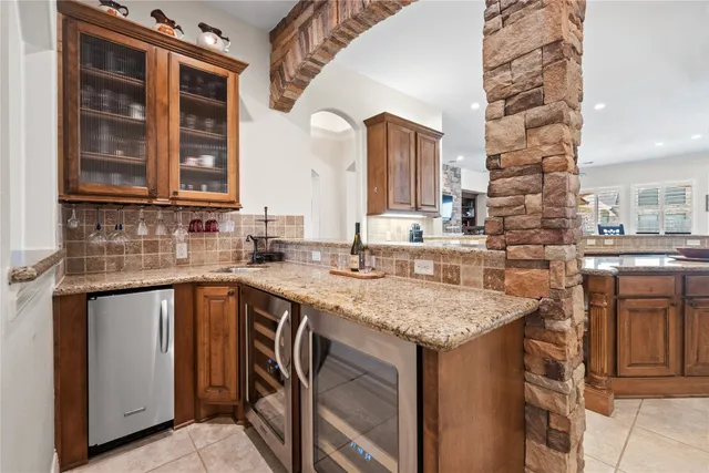 a kitchen with stainless steel appliances granite countertop a sink and cabinets