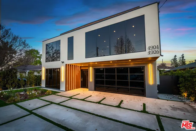 a view of a garden with wooden fence