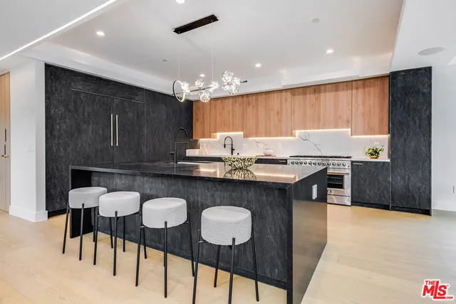 a bathroom with a granite countertop sink a toilet and shower