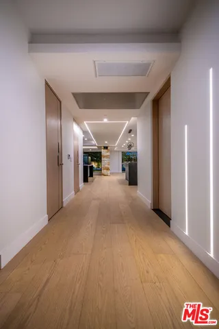 a living room with furniture and large windows