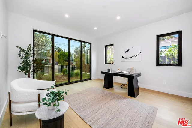a view of staircase with wooden floor and white walls