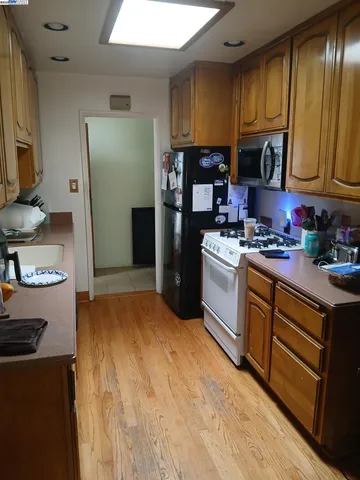 a kitchen with stainless steel appliances granite countertop a refrigerator a stove a sink and dishwasher