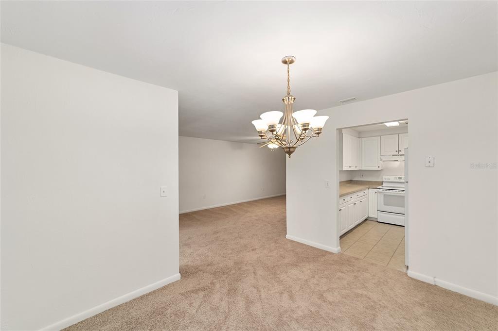 501 Southwest 75th Street, Unit H6 Gainesville, FL 32607 - Photo 11 of 42 a view of a kitchen with a sink cabinetry and chandelier