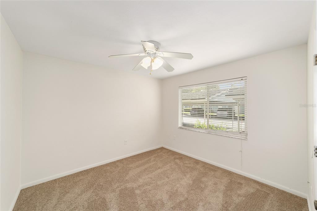 501 Southwest 75th Street, Unit H6 Gainesville, FL 32607 - Photo 16 of 42 an empty room with windows and fan
