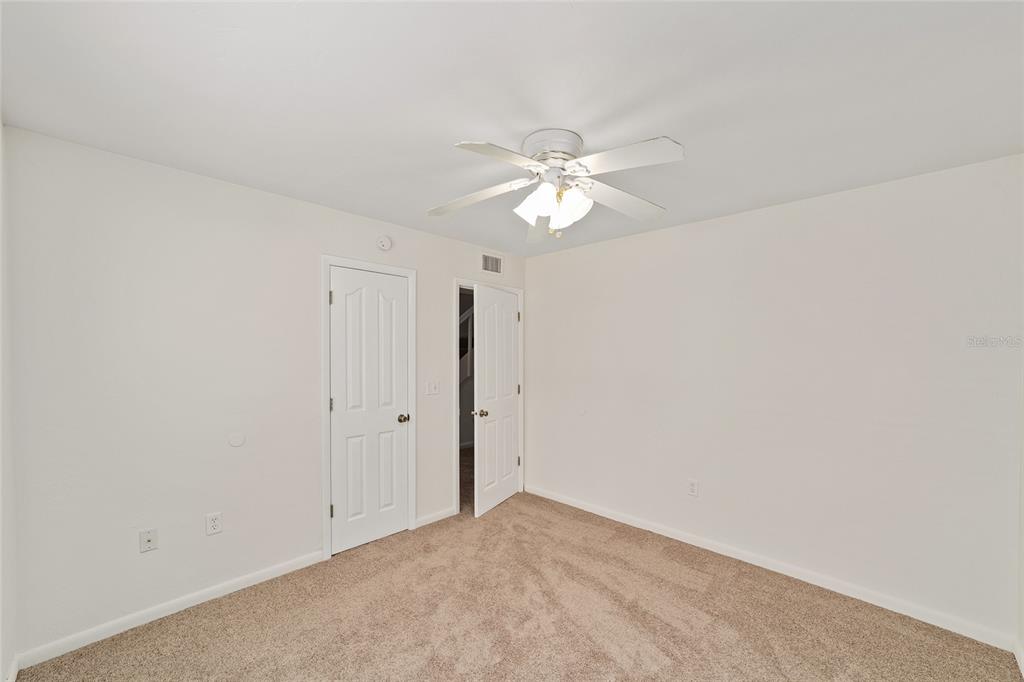 501 Southwest 75th Street, Unit H6 Gainesville, FL 32607 - Photo 17 of 42 an empty room with a ceiling fan and a window