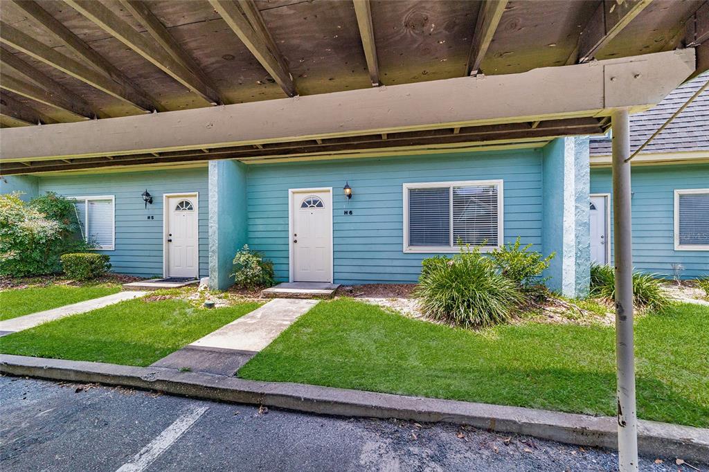 501 Southwest 75th Street, Unit H6 Gainesville, FL 32607 - Photo 2 of 42 a front view of a house with a yard