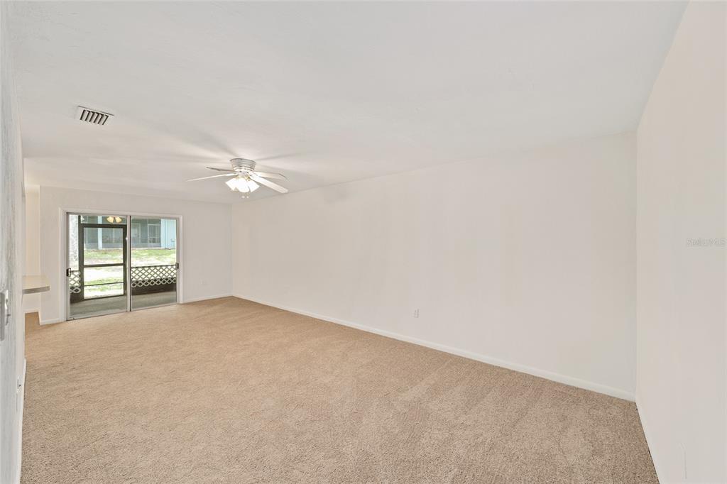 501 Southwest 75th Street, Unit H6 Gainesville, FL 32607 - Photo 21 of 42 an empty room with windows and fan