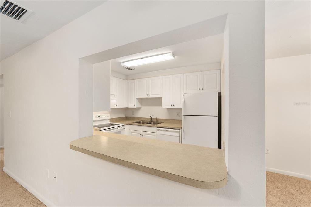 501 Southwest 75th Street, Unit H6 Gainesville, FL 32607 - Photo 8 of 42 a kitchen with stainless steel appliances granite countertop a refrigerator a stove and a sink