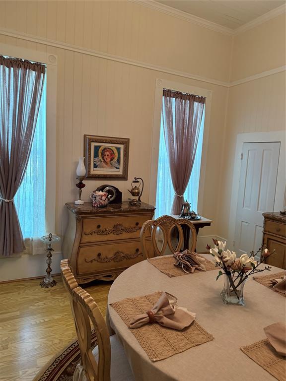 300 Northwest 3rd Street Hubbard, TX 76648 - Photo 16 of 25 Dining area with wood-finish flooring, two window openings, and crown molding