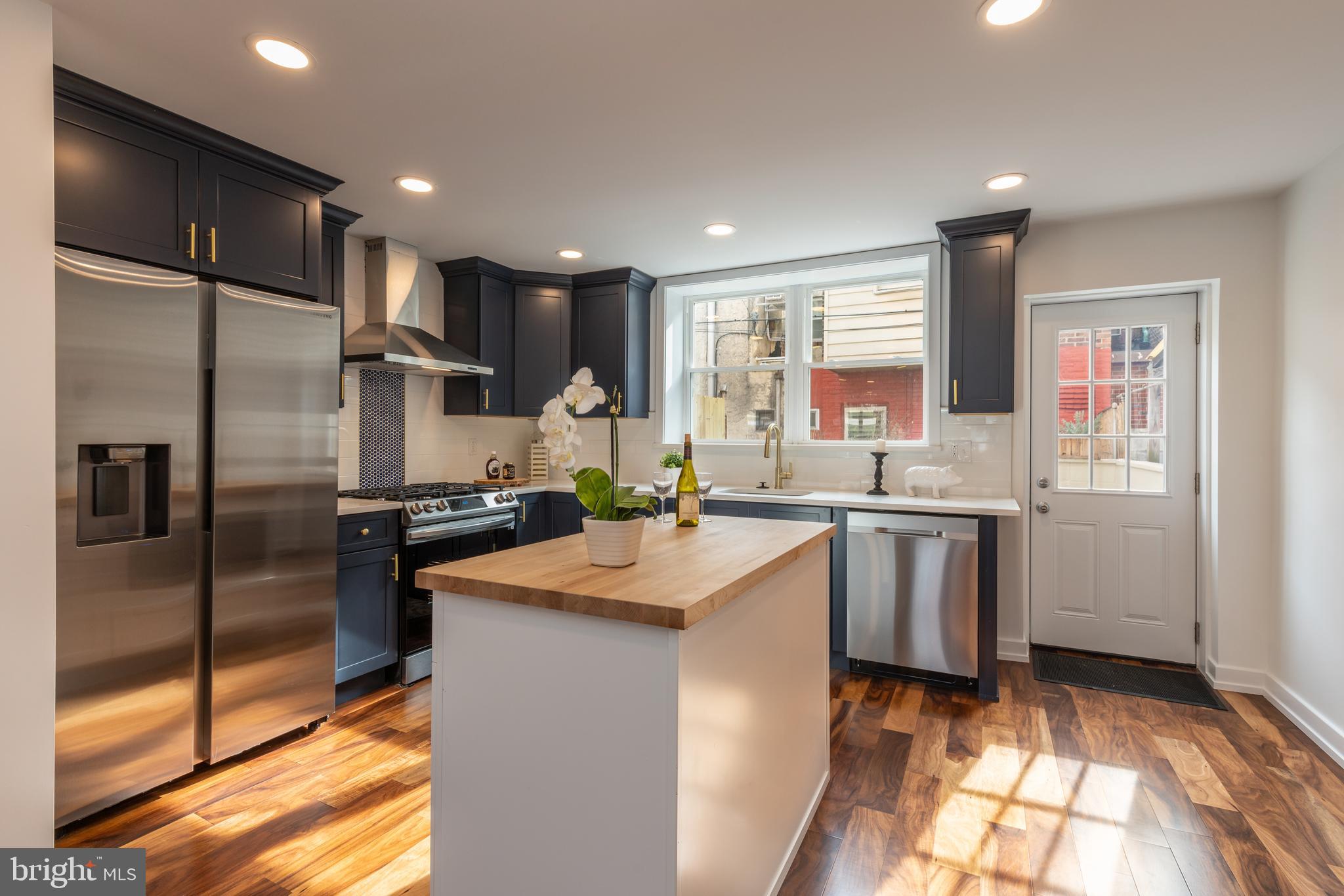 a kitchen with kitchen island granite countertop a sink appliances cabinets and counter space