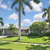 a view of a palm trees in front of a house