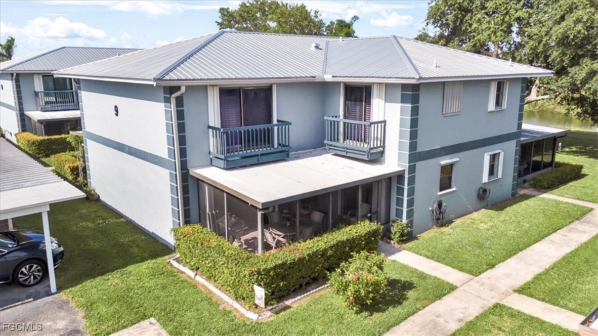 a aerial view of a house with a yard and large trees