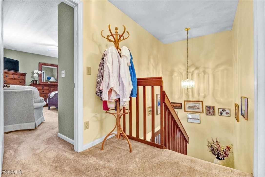 707 Hoover Dike Road, Unit 904 Clewiston, FL 33440 - Photo 19 of 38 a view of a hallway with a dining table and a chandelier