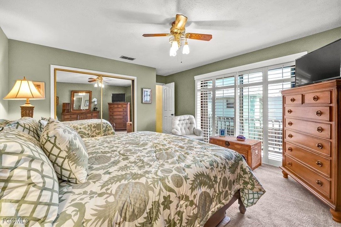 707 Hoover Dike Road, Unit 904 Clewiston, FL 33440 - Photo 21 of 38 a bedroom with a bed and a chandelier with a flat tv screen