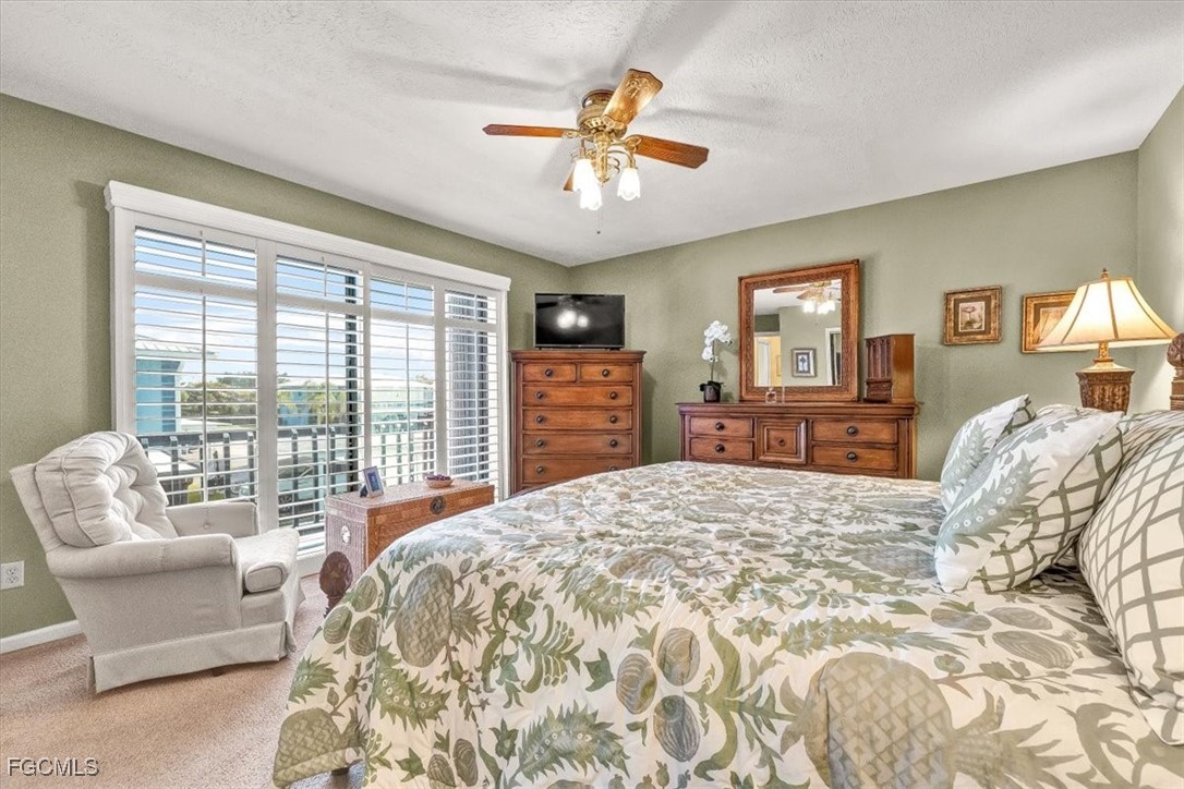 707 Hoover Dike Road, Unit 904 Clewiston, FL 33440 - Photo 22 of 38 a bedroom with a large bed and wooden floor
