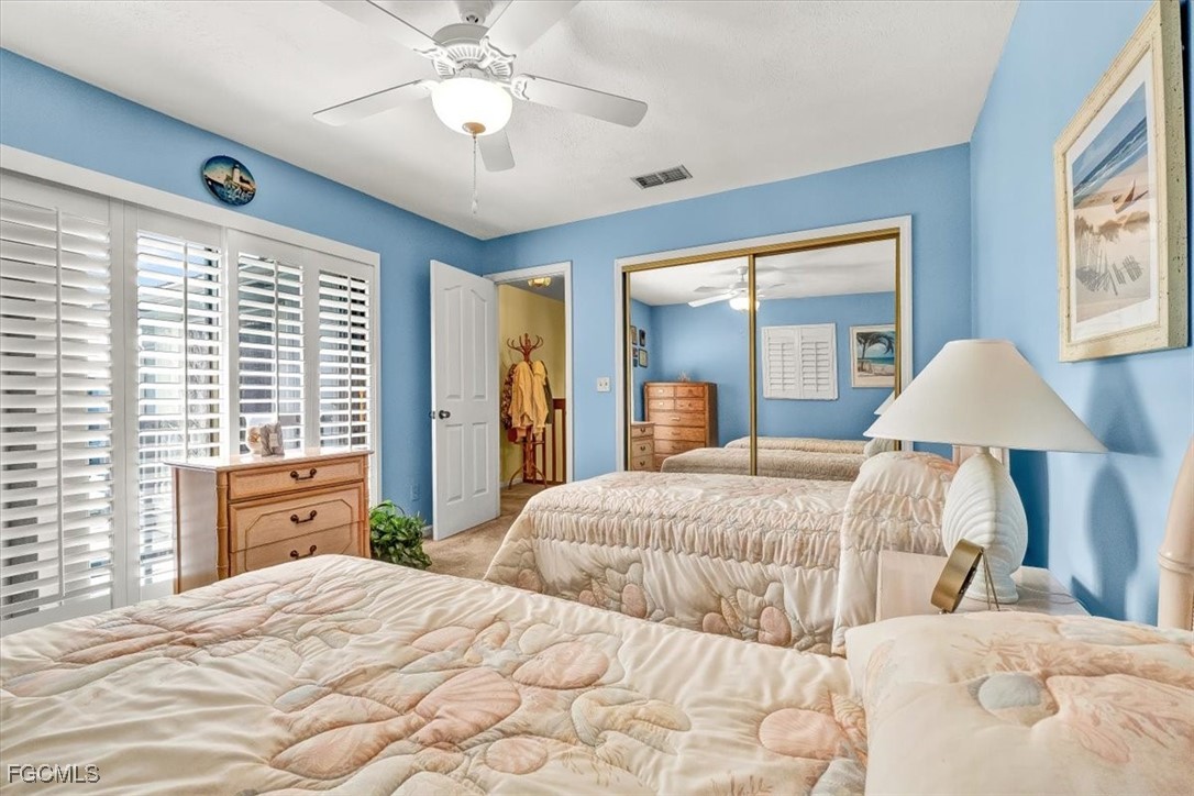 707 Hoover Dike Road, Unit 904 Clewiston, FL 33440 - Photo 27 of 38 a bedroom with a large bed and a chandelier
