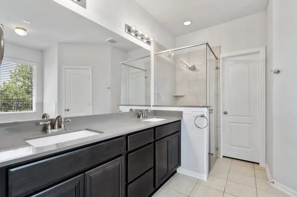 a white bath tub sitting in a bathroom next to a window