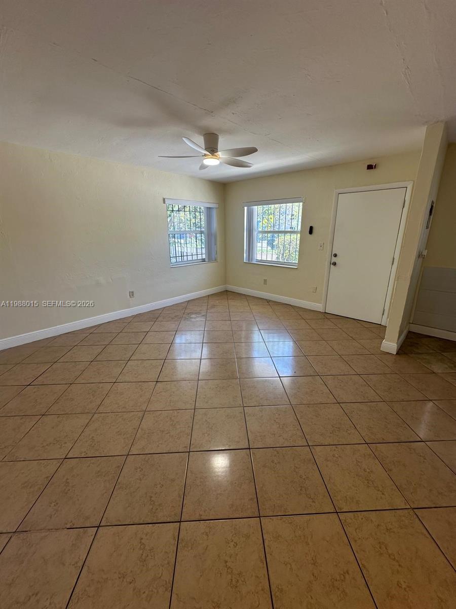 100 Northeast 78th Street, Unit 4 Miami, FL 33138 - Photo 8 of 12 a view of a livingroom with a window and brick walls