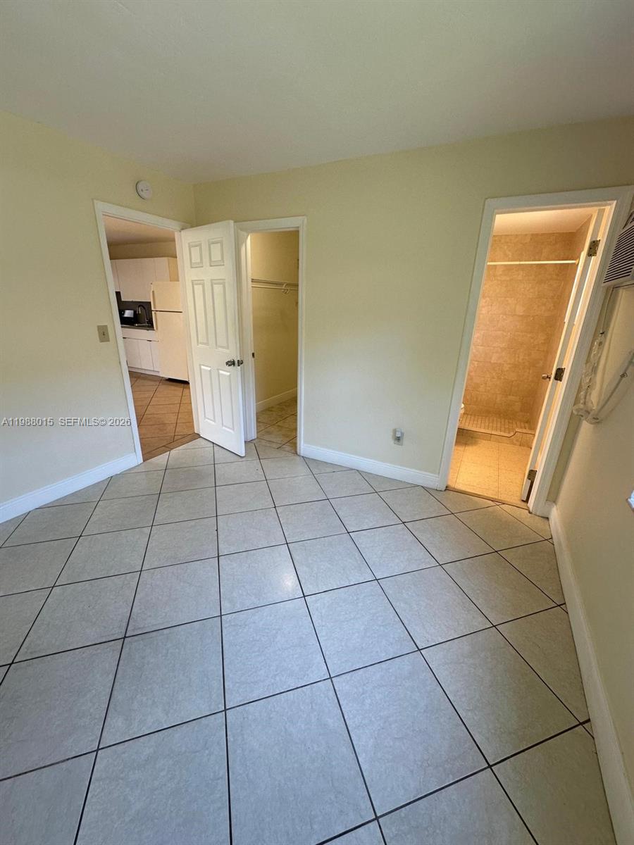 100 Northeast 78th Street, Unit 4 Miami, FL 33138 - Photo 9 of 12 a view of a livingroom with an empty space and a fireplace